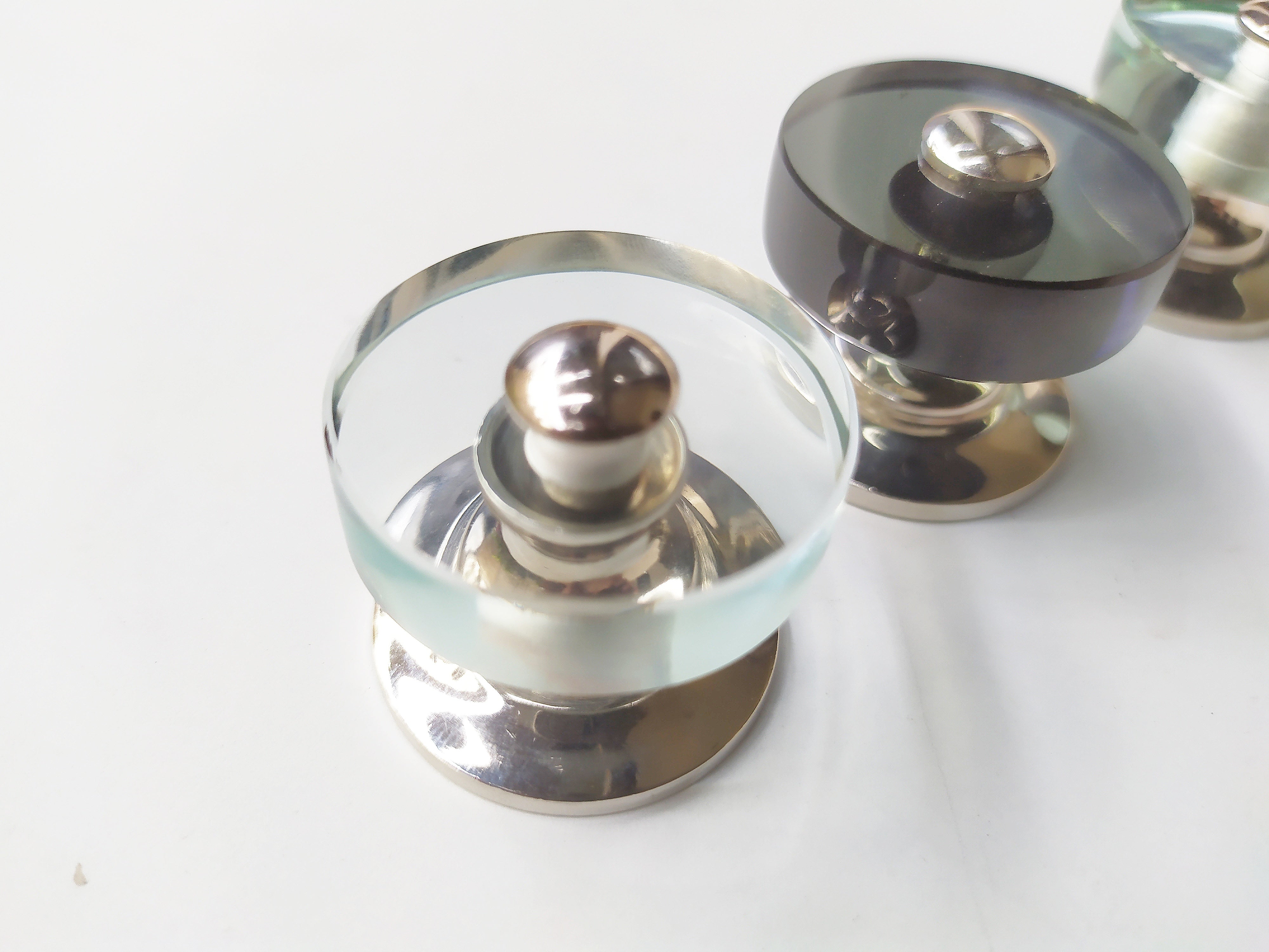 Flat round cabinet knob from glass and mirror , zoomed for details 